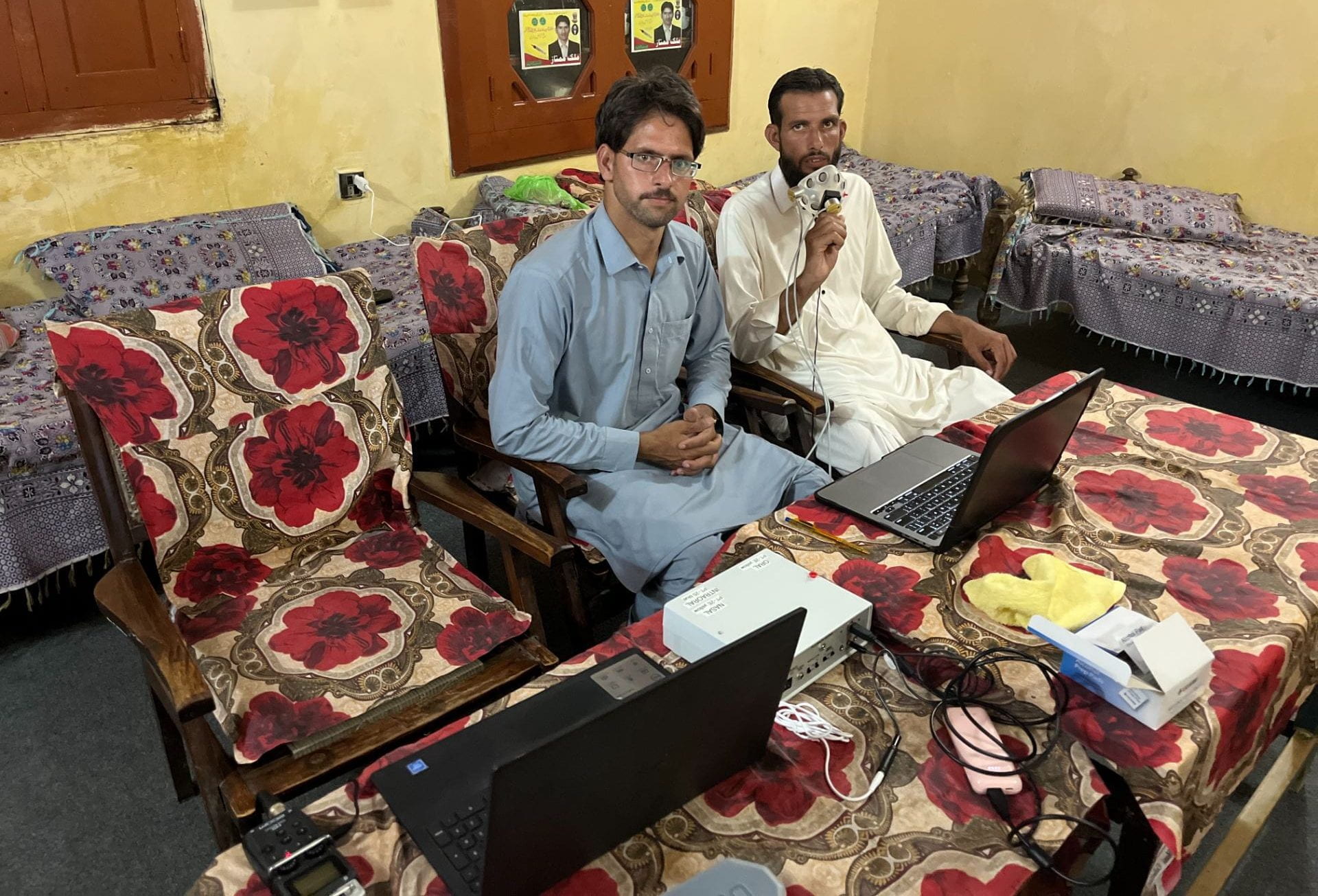 Two participants in the Mankiyali experiment learning about the oro-nasal airflow equipment. Two participants in the Mankiyali experiment learning about the oro-nasal airflow equipment.